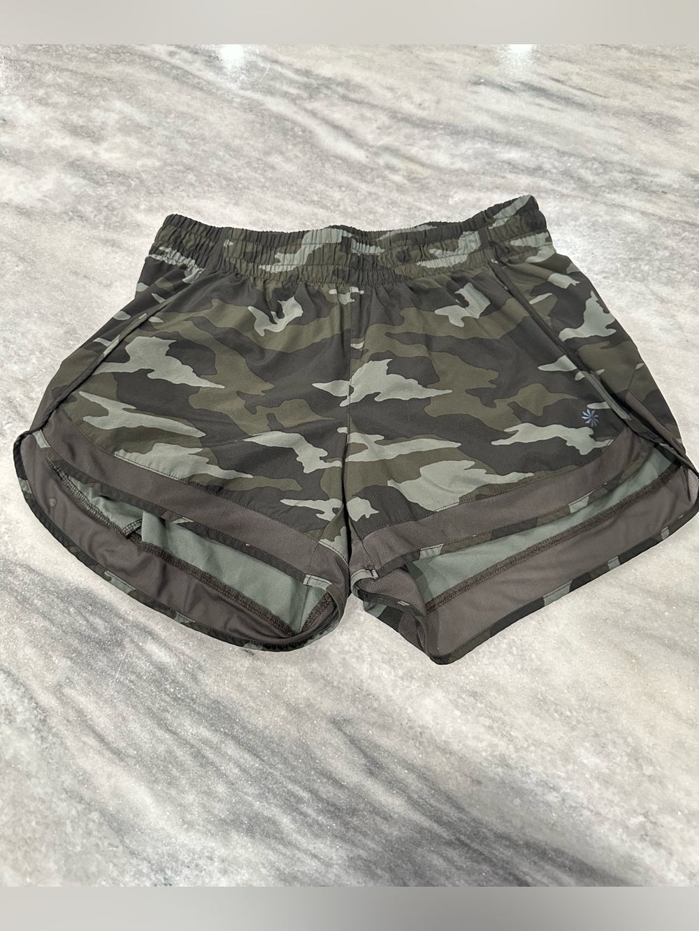 NWOT Athleta Printed Mesh Racer Run shorts in a green camo pattern